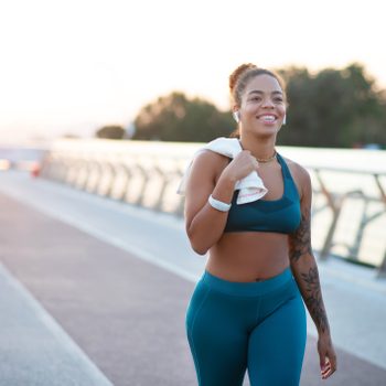 woman walking for exercise and smiling