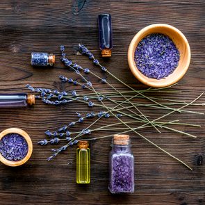 organic cosmetics with lavender on wooden background top view