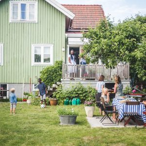 backyard filled with family and friends during the summer time