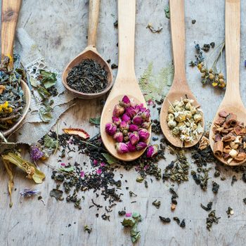 Dry tea with in wooden spoons. Top view