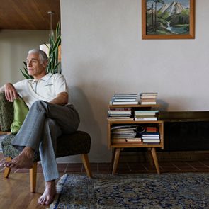 man sitting on chair in house