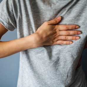 Woman is clutching her chest