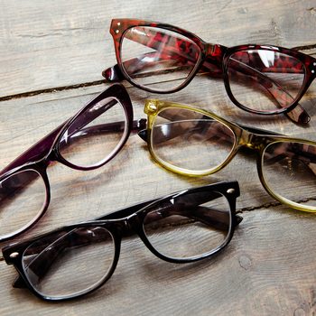 reading glasses on wooden background