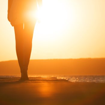 young woman's silhouette at sunset