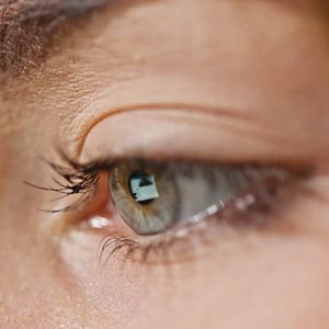 close up of screen reflection in woman's eye