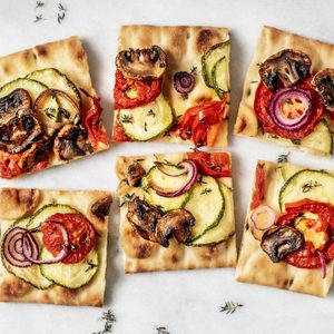 Vegetarian flatbread pizza on white background