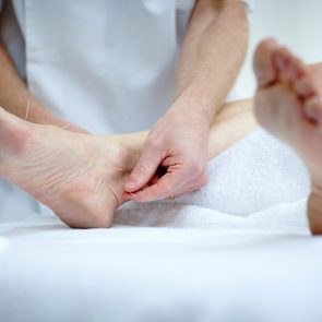 Woman's feet receiving acupuncture treatment