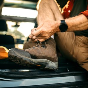 close up of man lacing up his hiking boots