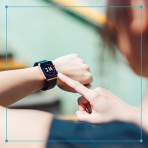 a woman checking her fitness tracker