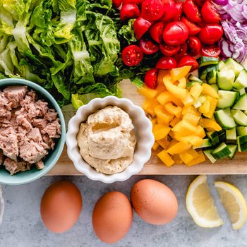 Egg and tuna salad ingredients on a chopping board